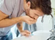 Man washing mouth after brushing teeth